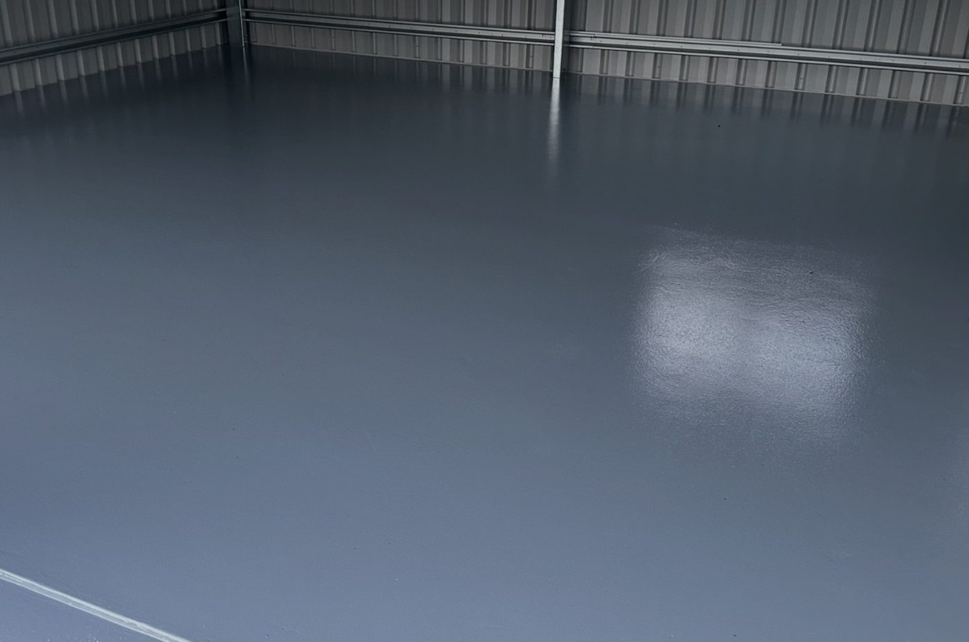 Glossy solid grey epoxy floor in a shed by Hobart Epoxy Floors
